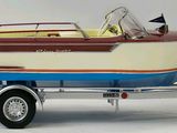 a small boat on a trailer on a white surface