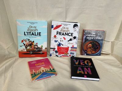 many books that are sitting on a bed together