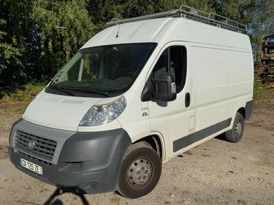 a white van parked in a lot with trees in the background