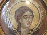painting of a woman with a red headband in a gold frame