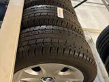 the wheels of a car are stacked on a rack in a garage
