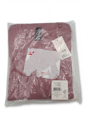 a close up of a shirt in a plastic bag on a white background