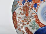 a close up of a decorative plate with a bird on it