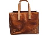 a brown leather handbag with a star design on the front