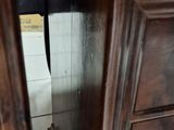 a wooden cabinet with a drawer on top of it