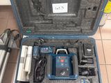 a blue tool case with tools in it on a tiled floor