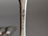 a silver spoon with a fork sticking out of it