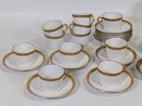 a lot of coffee cups and saucers sitting on a table