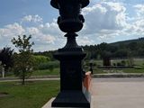 a large black urn sitting in the middle of a park
