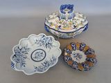 trois assiettes bleues et blanches et un bol posés sur une table