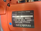 an orange electric sander sitting on top of a table in a store