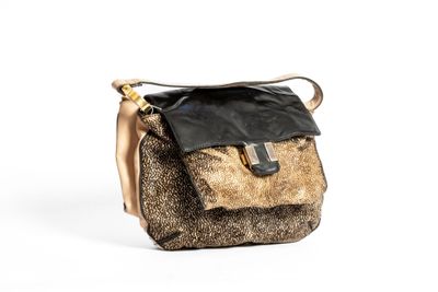 the brown and black purse is sitting on a white surface