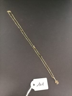 a close up of a necklace on a table with a price tag