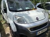 une petite camionnette blanche garée à côté d'une voiture