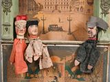 three dolls that are sitting on top of a box
