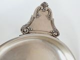 a silver plate with a mirror on top of it