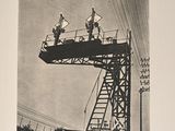 a black and white photo of people standing on a platform