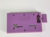 a purple electronic device on a white surface