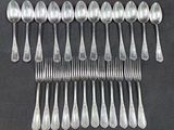 a lot of silver spoons and spoons on a table