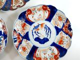 three plates with different designs on them sitting on a white surface