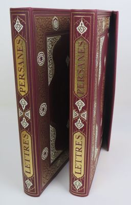 two books that are open on a white surface