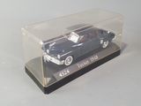 a black car in a clear box on a table