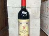 a bottle of wine sitting on a shelf in front of a stack of boxes