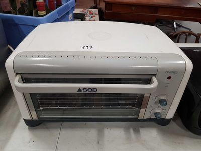 a toaster oven sitting on the floor in a room