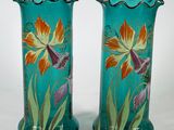 pair of hand painted glass vases on a white surface