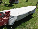 a small red truck with a tarp on the back of it