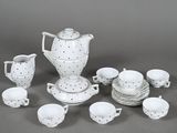 a white and black tea set with cups and saucers