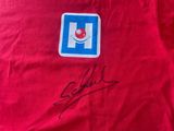 the back of a red t - shirt with a pepsi logo on it