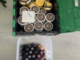 a container of coffee and a container of soda on the floor