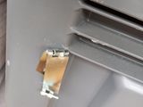 a close up of a piece of metal on the side of a building