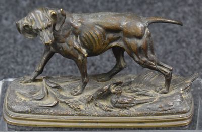 bronze statue of a dog with a duck in its mouth on a base