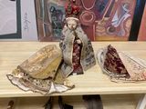 a statue of a woman sitting on top of a wooden table