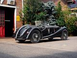 a black vintage car parked in front of a building