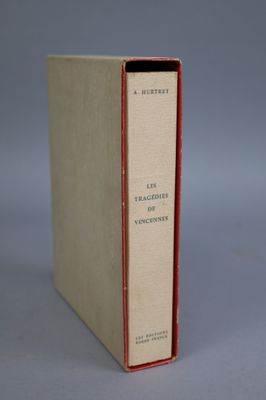 an old book sitting on top of a table next to a gray background