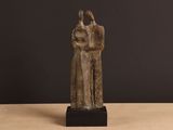 an image of a statue of a man and a woman on a table