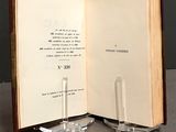 a open book with a glass candle holder on it