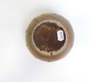 a brown vase sitting on a white surface