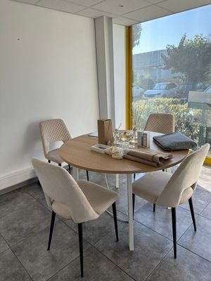 a table and chairs in a room with a large window
