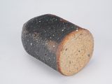 a piece of bread that is sitting on a white surface