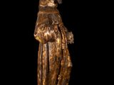 an old wooden statue of a man with a beard and a robe