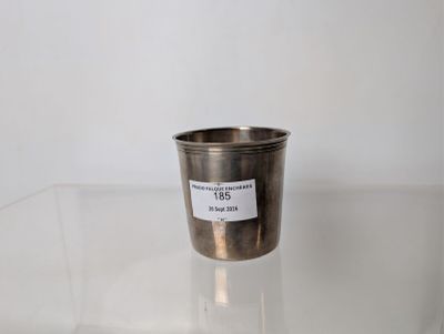 a silver cup sitting on a clear table