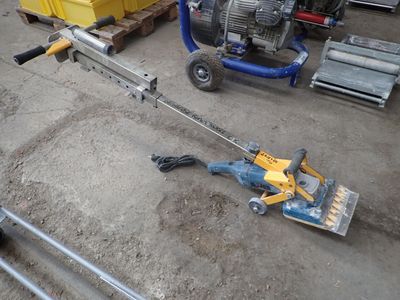 a machine that is sitting on the ground next to some pallets