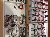 many pairs of glasses on the shelves in the store