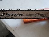 a chainsaw sitting on top of a table next to a toilet