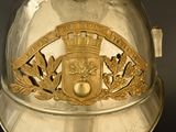 a silver helmet with a gold emblem on it