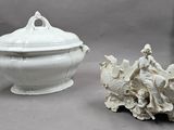 a white bowl with a lid sitting next to a sea shell